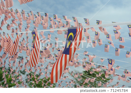SELANGOR, MALAYSIA -AUGUST 31, 2017: Selective focused small size Malaysia flag tie in large quantities in windy air.  71245784