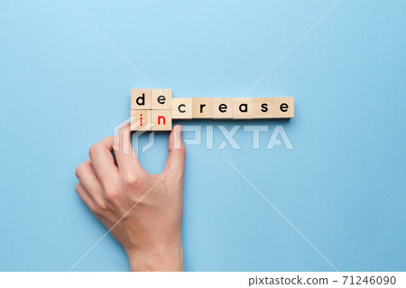 Concept of decrease and increase on wooden cubes 71246090