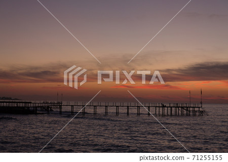 Beautiful sunset on the sea and the pier. Beautiful sunset on the sea and the pier. 71255155