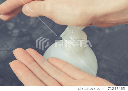 Hands with disinfectant liquid or soap for disinfection hands. Stop spreading virus and bacteria Hands with disinfectant liquid or soap for disinfection hands. Stop spreading virus and bacteria 71257465