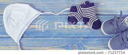 Clothing and apparel for newborn, extending family and expecting for baby concept, place for text Clothing and apparel for newborn, extending family and expecting for baby concept, place for text 71257714