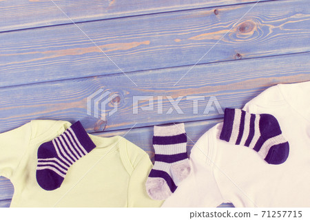 Vintage photo. Clothes for little baby boy, extending family concept, copy space for text Vintage photo. Clothes for little baby boy, extending family concept, copy space for text 71257715