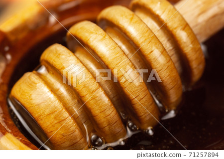 bucket of collecting from a jar of honey. Jars of honey. close-up macro 71257894