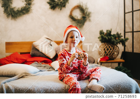 Cute boy eating delicious cookie at home Cute boy eating delicious cookie at home 71258693