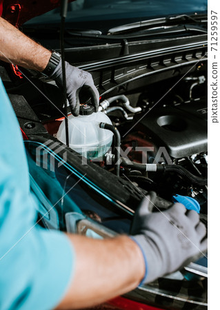 Mechanic examinates the cars technical conditions. Exterior view of a new car 71259597