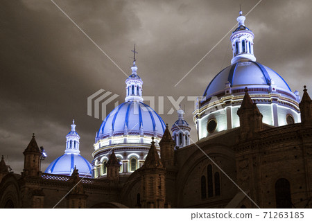 Famous domes of the New Cathedral in Cuenca, Ecuador rise over the city skyline at dusk Famous domes of the New Cathedral in Cuenca, Ecuador rise over the city skyline at dusk 71263185