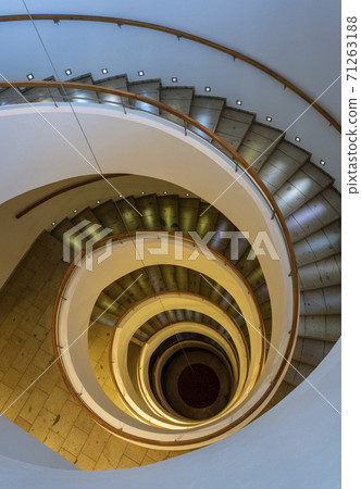 Spiral Staircase Leads Down Several Floors With Dramatic Lighting Spiral Staircase Leads Down Several Floors With Dramatic Lighting 71263188