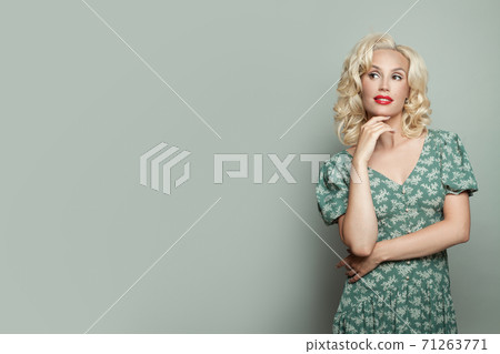 Attractive woman with makeup and blonde curly hair Attractive woman with makeup and blonde curly hair 71263771