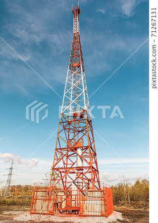 New telecommunication antenna on background of blue sky in the forest. Satellite dish telecom network at communication technology network. Telecom broadcasting tower. Cell tower 71267131
