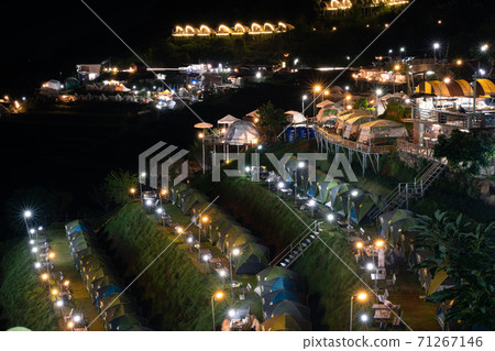 Beautiful view landscape of camping tents with Mon jam mountain landscape and resorts at night light, Chiang mai. Thailand 71267146
