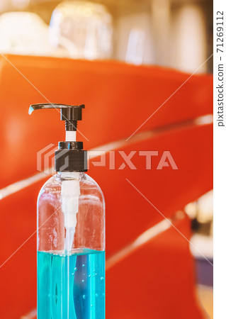 Blue alcohol gel bottle for hands cleaning to prevent the spreading of the Corona virus (Covid-19), Place the entrance service for customers in the cafe. Healthcare concept. New normal lifestyle. Blue alcohol gel bottle for hands cleaning to prevent the spreading of the Corona virus (Covid-19), Place the entrance service for customers in the cafe. Healthcare concept. New normal lifestyle. 71269112