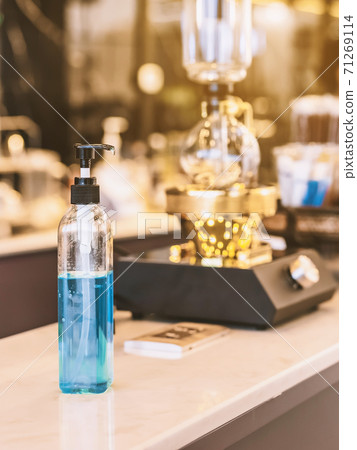 Blue alcohol gel bottle for hands cleaning to prevent the spreading of the Corona virus (Covid-19), Place the entrance service for customers in the cafe. Healthcare concept. New normal lifestyle. Blue alcohol gel bottle for hands cleaning to prevent the spreading of the Corona virus (Covid-19), Place the entrance service for customers in the cafe. Healthcare concept. New normal lifestyle. 71269114
