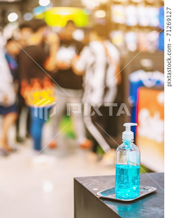 Blue alcohol gel bottle for hands cleaning to prevent the spreading of the Corona virus (Covid-19),Place the entrance service for customers in the sport store.Healthcare concept.New normal lifestyle. Blue alcohol gel bottle for hands cleaning to prevent the spreading of the Corona virus (Covid-19),Place the entrance service for customers in the sport store.Healthcare concept.New normal lifestyle. 71269127