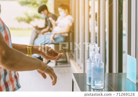 Blue alcohol gel bottle for hands cleaning to prevent the spreading of the Corona virus (Covid-19),Place the entrance service for customers in the sport store.Healthcare concept.New normal lifestyle. Blue alcohol gel bottle for hands cleaning to prevent the spreading of the Corona virus (Covid-19),Place the entrance service for customers in the sport store.Healthcare concept.New normal lifestyle. 71269128