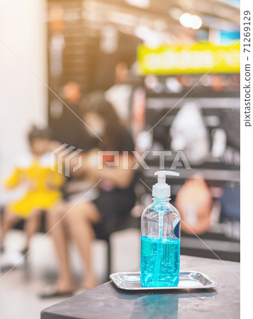Blue alcohol gel bottle for hands cleaning to prevent the spreading of the Corona virus (Covid-19),Place the entrance service for customers in the sport store.Healthcare concept.New normal lifestyle. Blue alcohol gel bottle for hands cleaning to prevent the spreading of the Corona virus (Covid-19),Place the entrance service for customers in the sport store.Healthcare concept.New normal lifestyle. 71269129