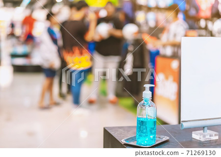 Blue alcohol gel bottle for hands cleaning to prevent the spreading of the Corona virus (Covid-19),Place the entrance service for customers  in the sport store.Healthcare concept.New normal lifestyle. 71269130