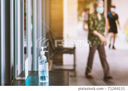 Blue alcohol gel bottle for hands cleaning to prevent the spreading of the Corona virus (Covid-19), Place the entrance service for customers  in the cafe. Healthcare concept. New normal lifestyle. 71269131