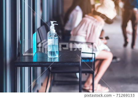 Blue alcohol gel bottle for hands cleaning to prevent the spreading of the Corona virus (Covid-19), Place the entrance service for customers  in the cafe. Healthcare concept. New normal lifestyle. 71269133