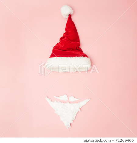 Christmas concert, New Year's hat and beard on a pink background, top view, copy space Christmas concert, New Year's hat and beard on a pink background, top view, copy space 71269460