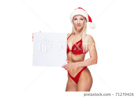 Sexy female bodybuilder in a red swimsuit and Christmas hat, copy space, isolated on white Sexy female bodybuilder in a red swimsuit and Christmas hat, copy space, isolated on white 71270426