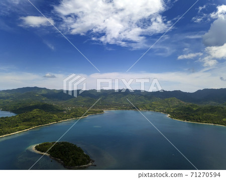 Lombok, Indonesia, south Gili islands. Aerial drone view from the Gili Asahan island  to the sea and the highlands of Lombok. 71270594