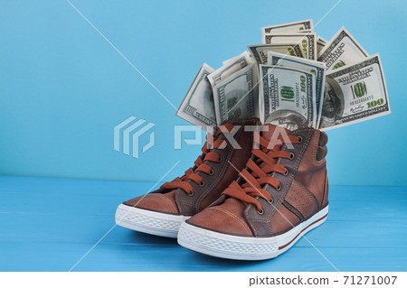 Sneakers shoes with dollar banknotes. Sneakers shoes with dollar banknotes. 71271007