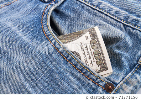Close-up dollars in a jeans pocket. 71271156