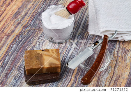 Shaving accessories on a wooden background. 71271252