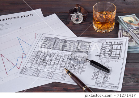 Business papers with building layout and pen. 71271417