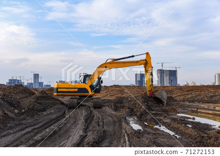 Excavator during excavation at construction site. Excavator during excavation at construction site. 71272153