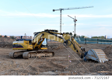 Excavator on eartwork working at construction site. Excavator on eartwork working at construction site. 71272167