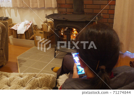 Women and wood stove 71274844