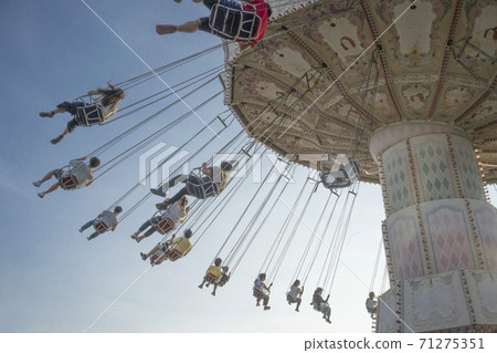 Amusement park swing swings that customers are enjoying Amusement park swing swings that customers are enjoying 71275351