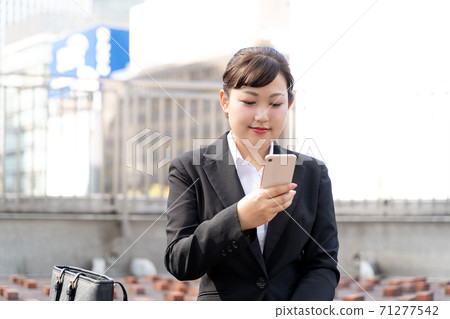 Young female employee checking email / woman looking for a job Young female employee checking email / woman looking for a job 71277542