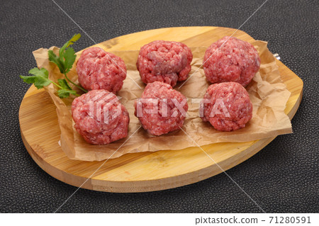 Raw meatball over wooden background Raw meatball over wooden background 71280591