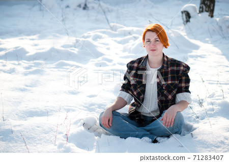Young woman meditates in winter park. 71283407