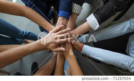 Diverse people business partners friends colleagues stacking palms in pile Diverse people business partners friends colleagues stacking palms in pile 71287034