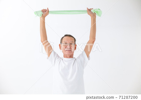 Senior man stretching with a towel Senior man stretching with a towel 71287200