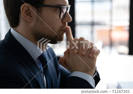 30s businessman in formal suit thinking of problem solution. 30s businessman in formal suit thinking of problem solution. 71287201