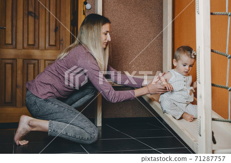 Active games for Baby indoors activities. Toddler girl play with mom on home Wooden playsets. Play Gym, Home and School Indoor Wooden Playground Equipment for kids Children with Climbing Net, Slide 71287757