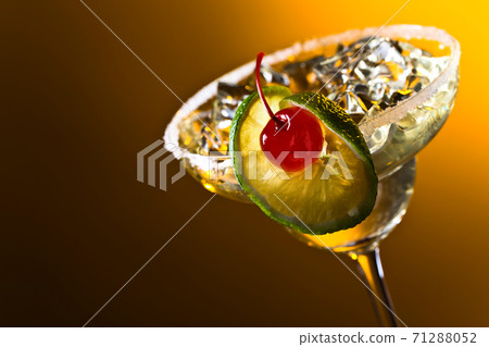 Alcoholic cocktail with cherry and lime. Alcoholic cocktail with cherry and lime. 71288052