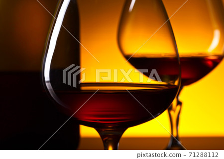 glasses of brandy on  on a yellow background 71288112