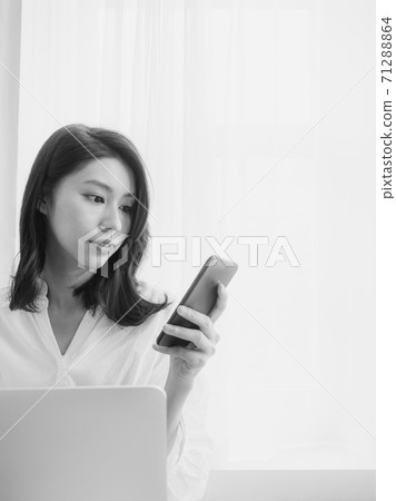 Young asian woman using smartphone at home Young asian woman using smartphone at home 71288864