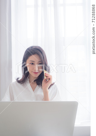 Young asian beauty shopping online with credit card and laptop Young asian beauty shopping online with credit card and laptop 71288868