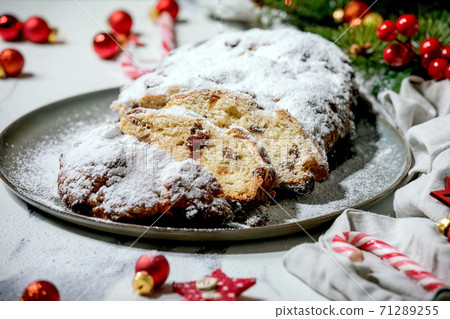 Christmas baking stollen cake with xmas decorations over white marble 71289255
