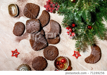 Christmas shortcrust cookies chocolate crescents with fir tree, molds, xmas decorations. Top view 71289256