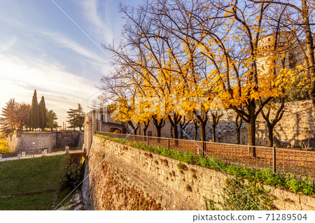 Beautiful view of the central entrance to the castle of the Brescia city during the golden autumn 71289504
