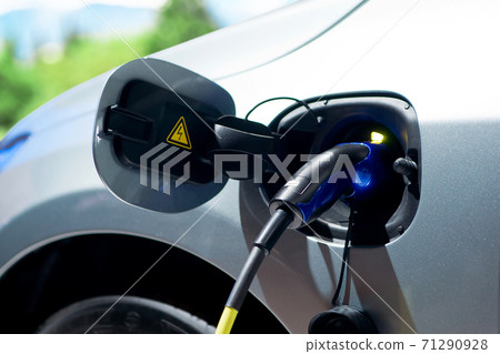 Electric car charging at station Electric car charging at station 71290928