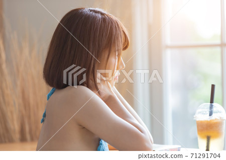 Portrait of young pretty sexy Asian woman wearing blue bikini in her room. Portrait of young pretty sexy Asian woman wearing blue bikini in her room. 71291704