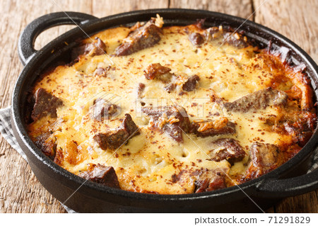 Tave kosi is a national Albanian dish of baked lamb and rice with yoghurt close-up in a pan. horizontal 71291829